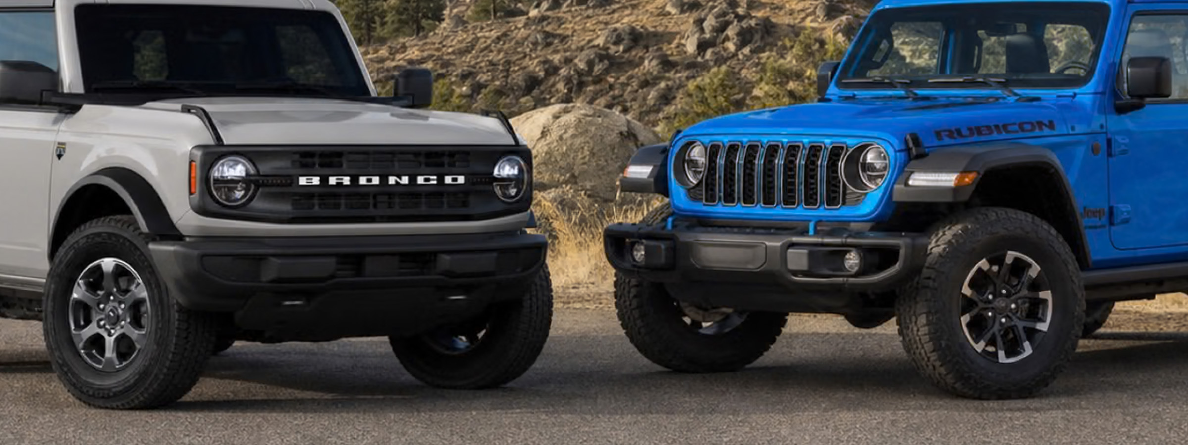 Ford Bronco and Jeep Wrangler on a dirt road
