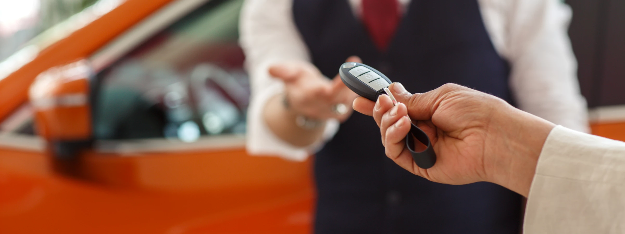 A valet driver receiving a Nissan's keys