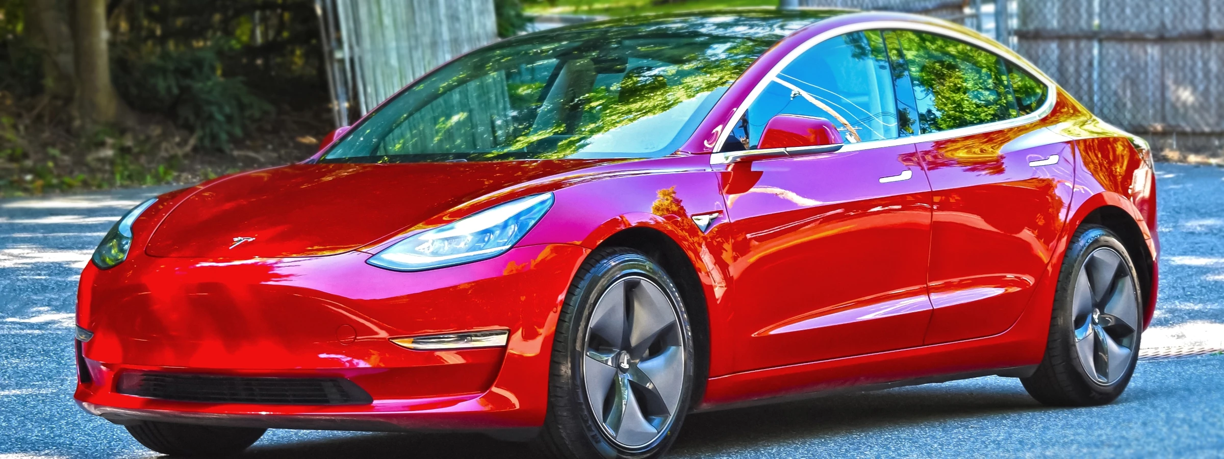 An efficient red Tesla Model 3.