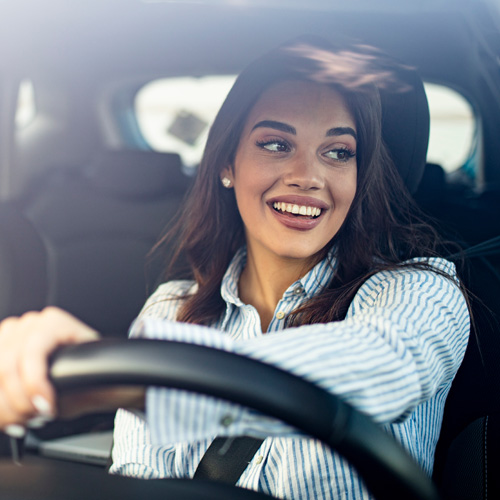 Smiling man putting on a seatbelt.