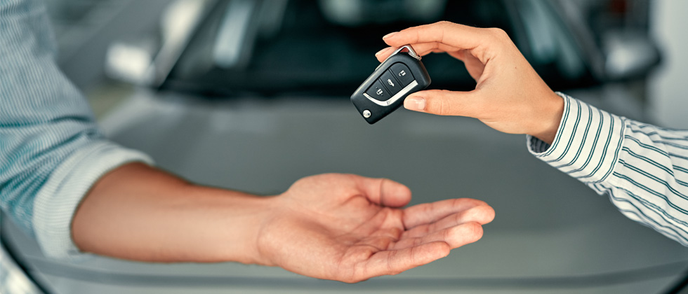 Person handing over car keys.