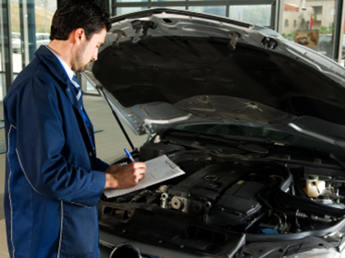 A mechanic examining a vehicle's engine