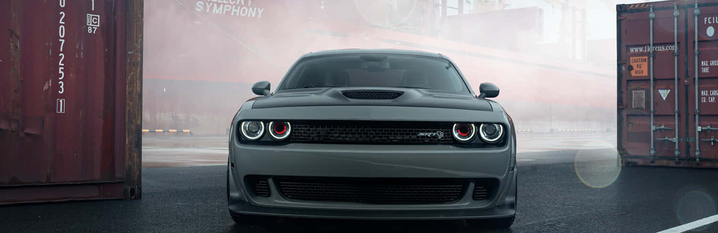 A green Dodge Challenger SRT in a loading dock