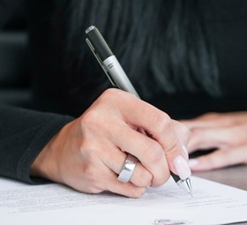 Customer signing vehicle financing paperwork