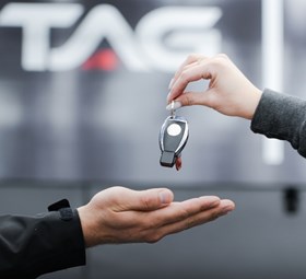 Car key being handed over at TopLine Auto Group