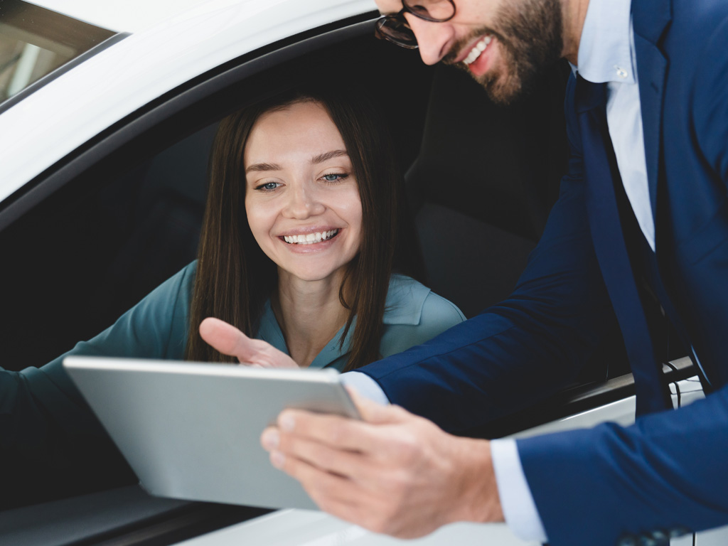 Salesman showing a buyer financing options.