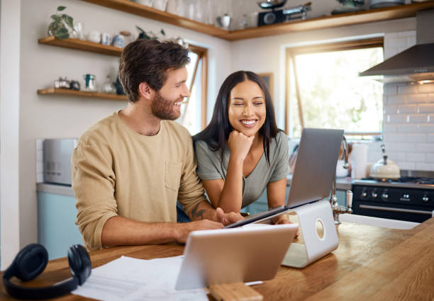 Two People Using Laptop