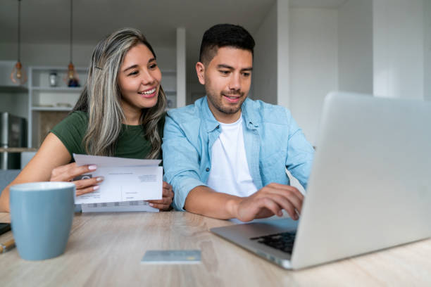 Two People Using Laptop