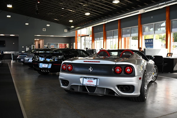 A lineup of luxury cars in the showroom at Seattle Finest Motors.