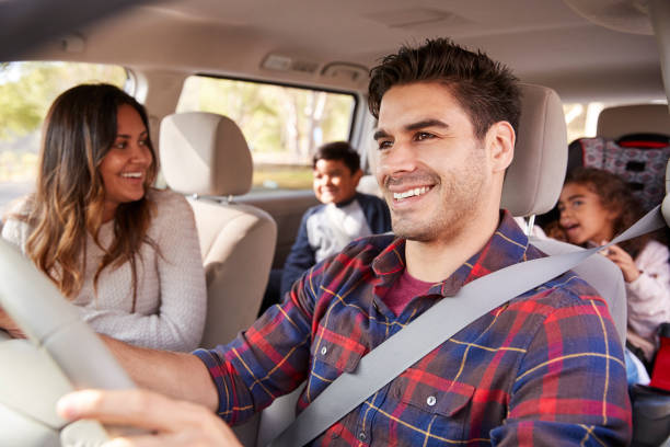 Happy family in the car approved for a car loan despite having a bad credit with Byron center Motors in Byron Center MI