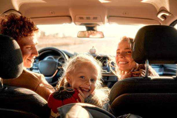 Happy family driving away in their vehicle after being approved for a car loan with bad credit with Byron center Motors in Byron Center MI