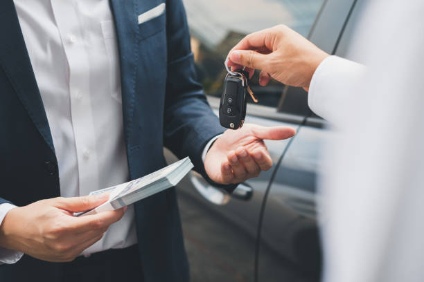 Customer getting keys after financing first ever vehicle at Used car dealership Byron center Motors, Byron Center MI