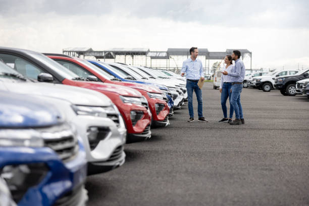 customers shaking hands with employee accepting new credit acceptance auto loan regardless of their bad credit at Used car dealership Byron center Motors, Byron Center MI